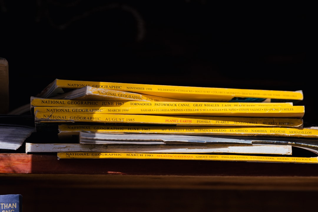 a stack of books sitting on top of a wooden table