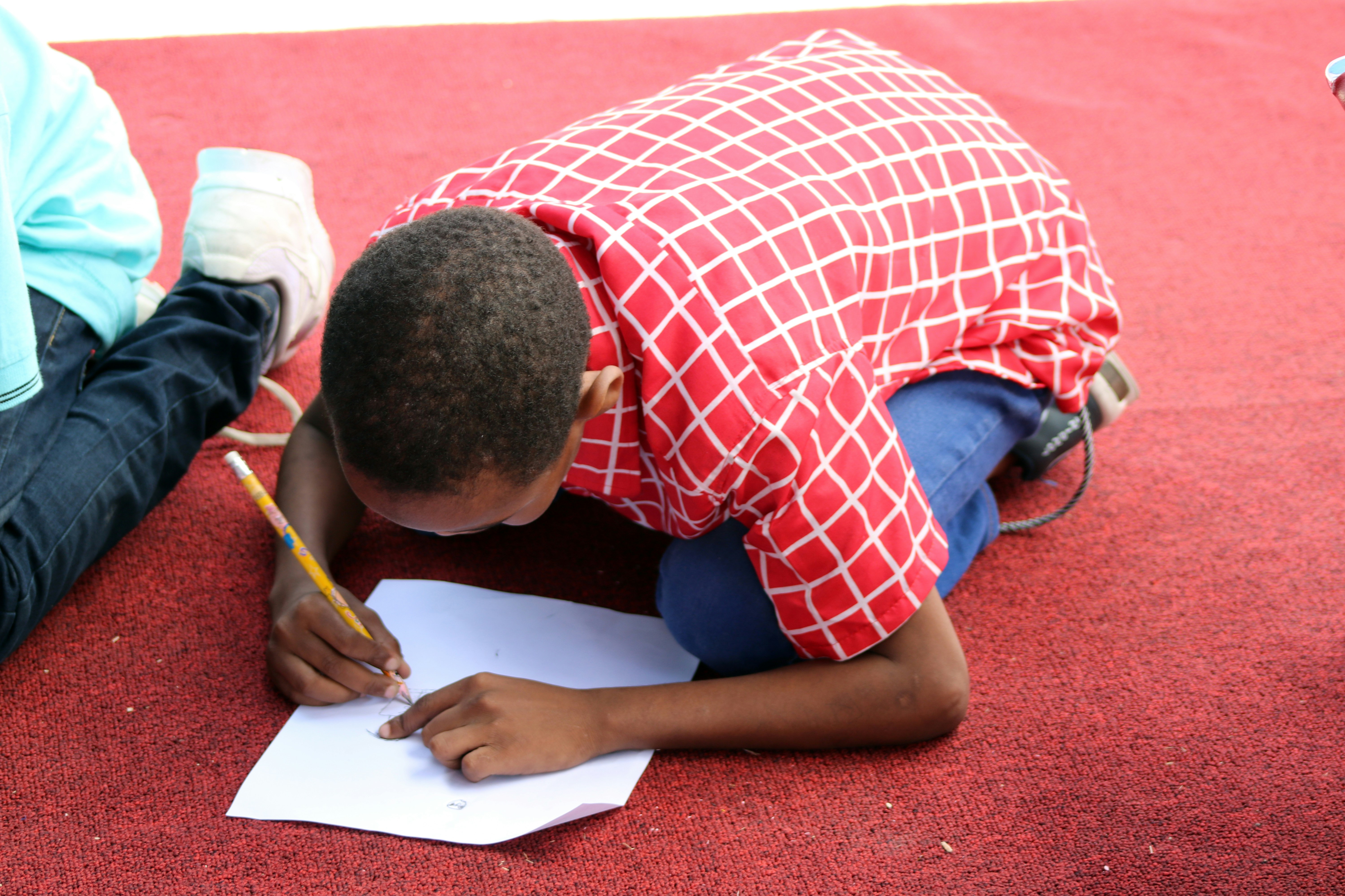 ❓ FAQ: Your Burning Questions About Writing Drama Scripts for School Students Answered by School Play Scripts man in red and white plaid button up shirt writing on white paper