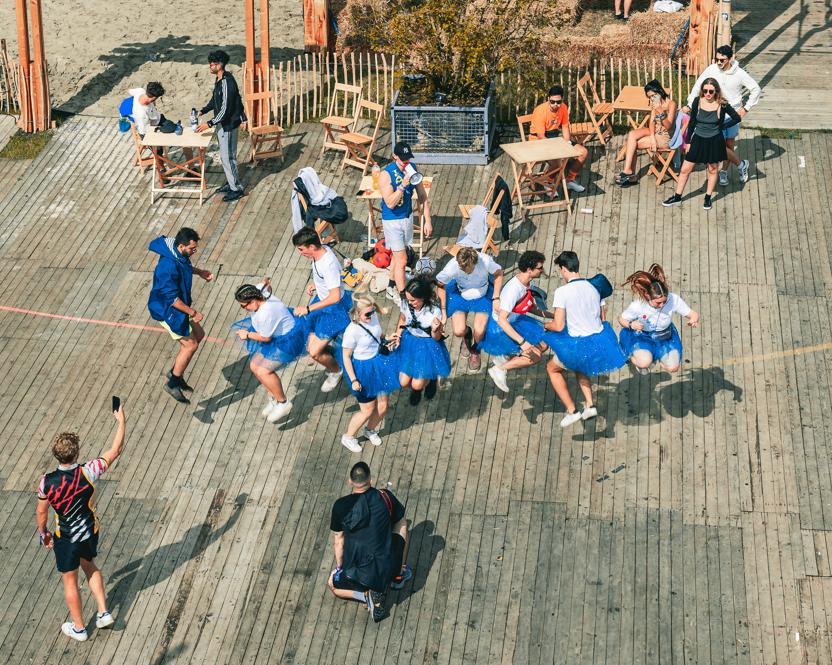 a group of people dressed in blue skirts