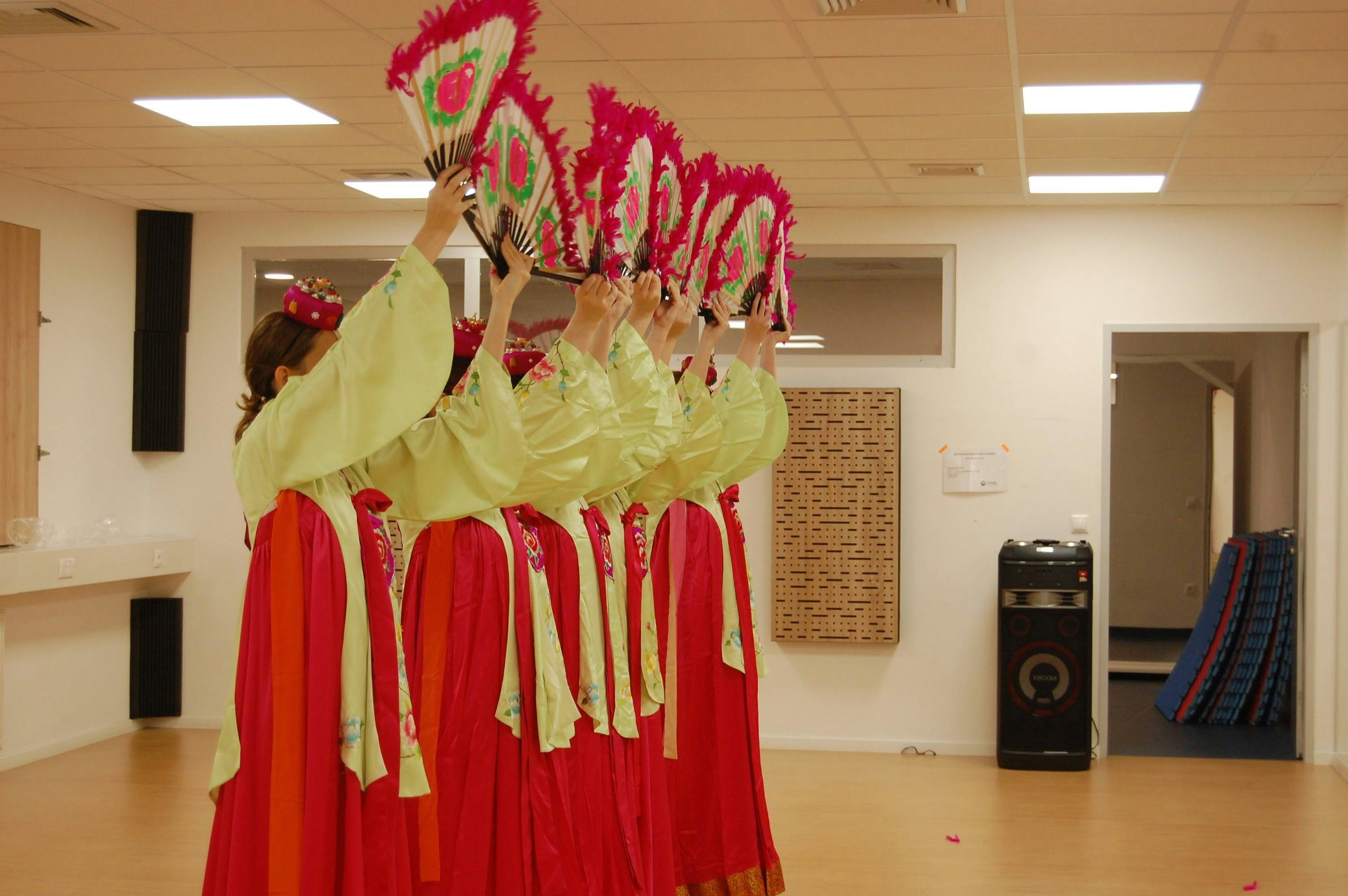 A group of women in red and yellow dresses