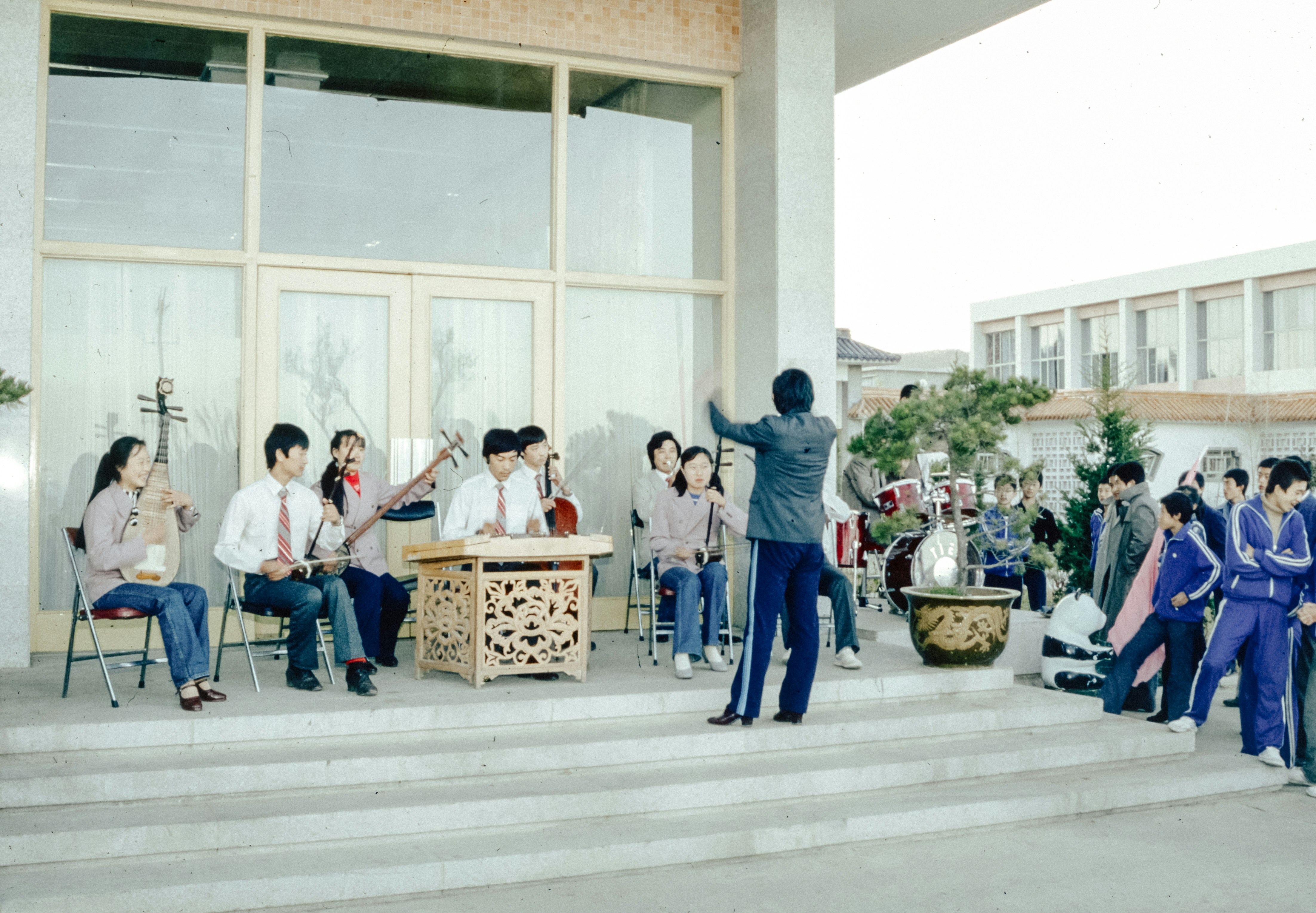 A group of people sitting on the steps of a building