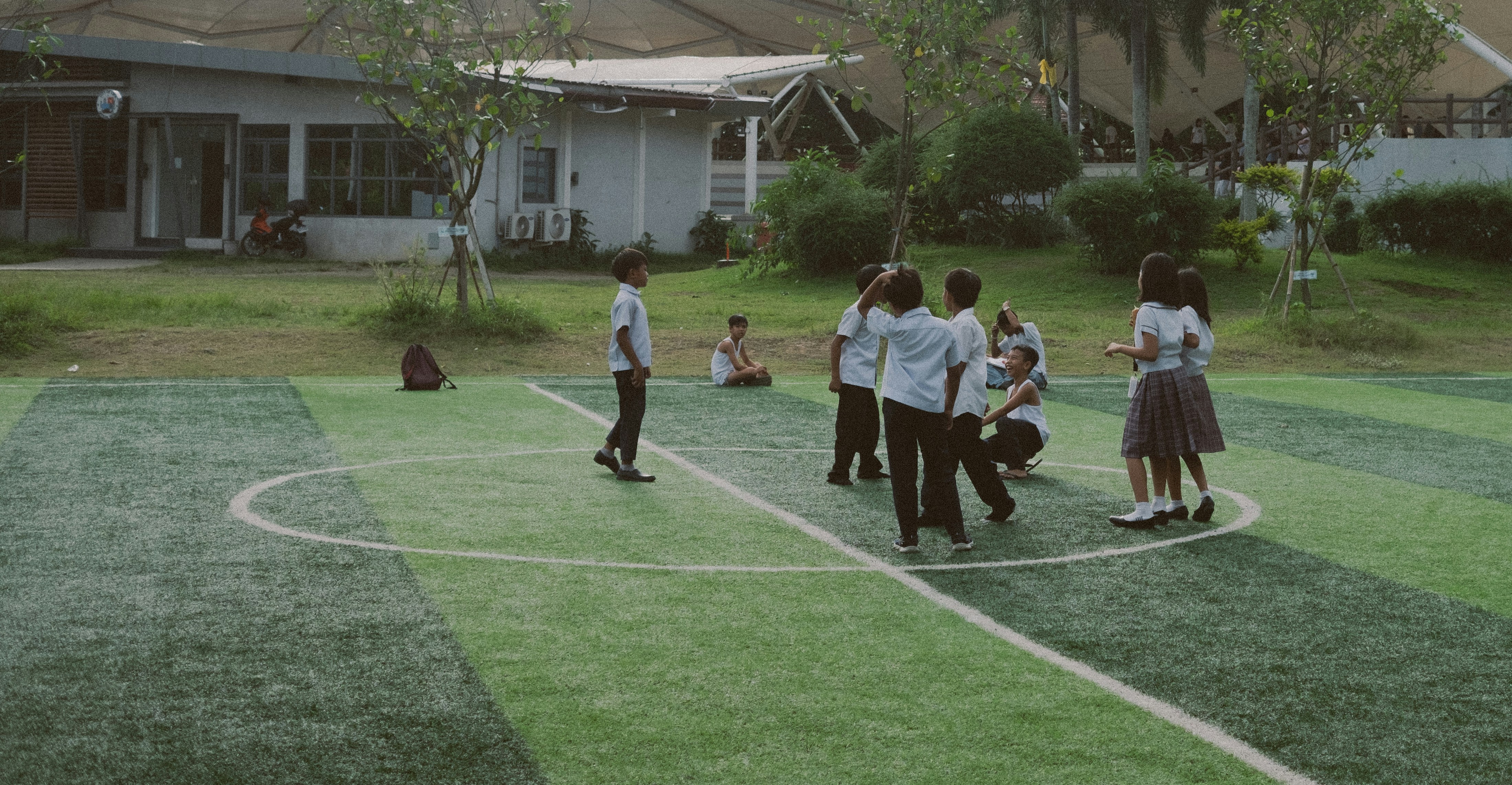 A group of people standing on top of a basketball court