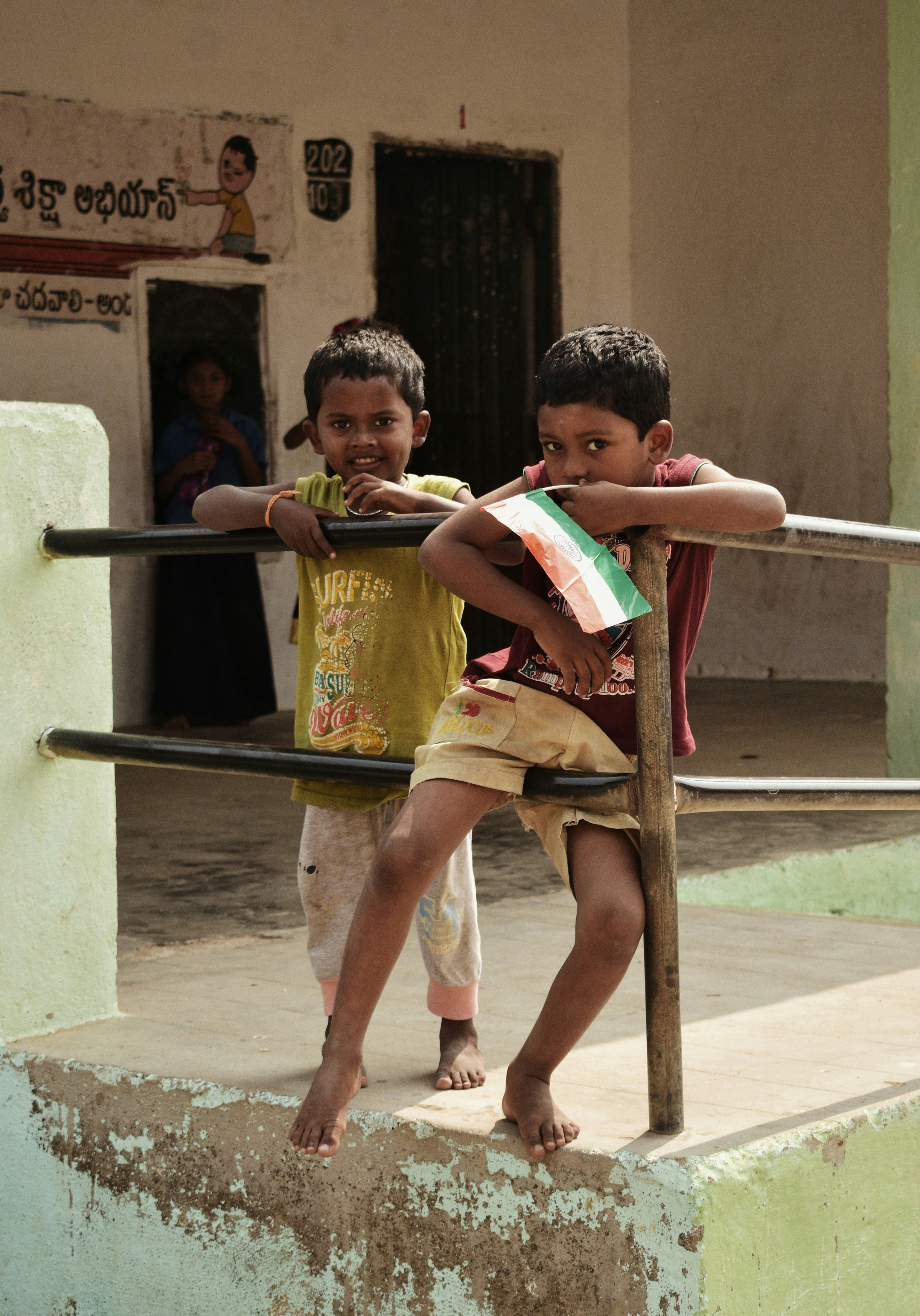 two toddler standing near railings