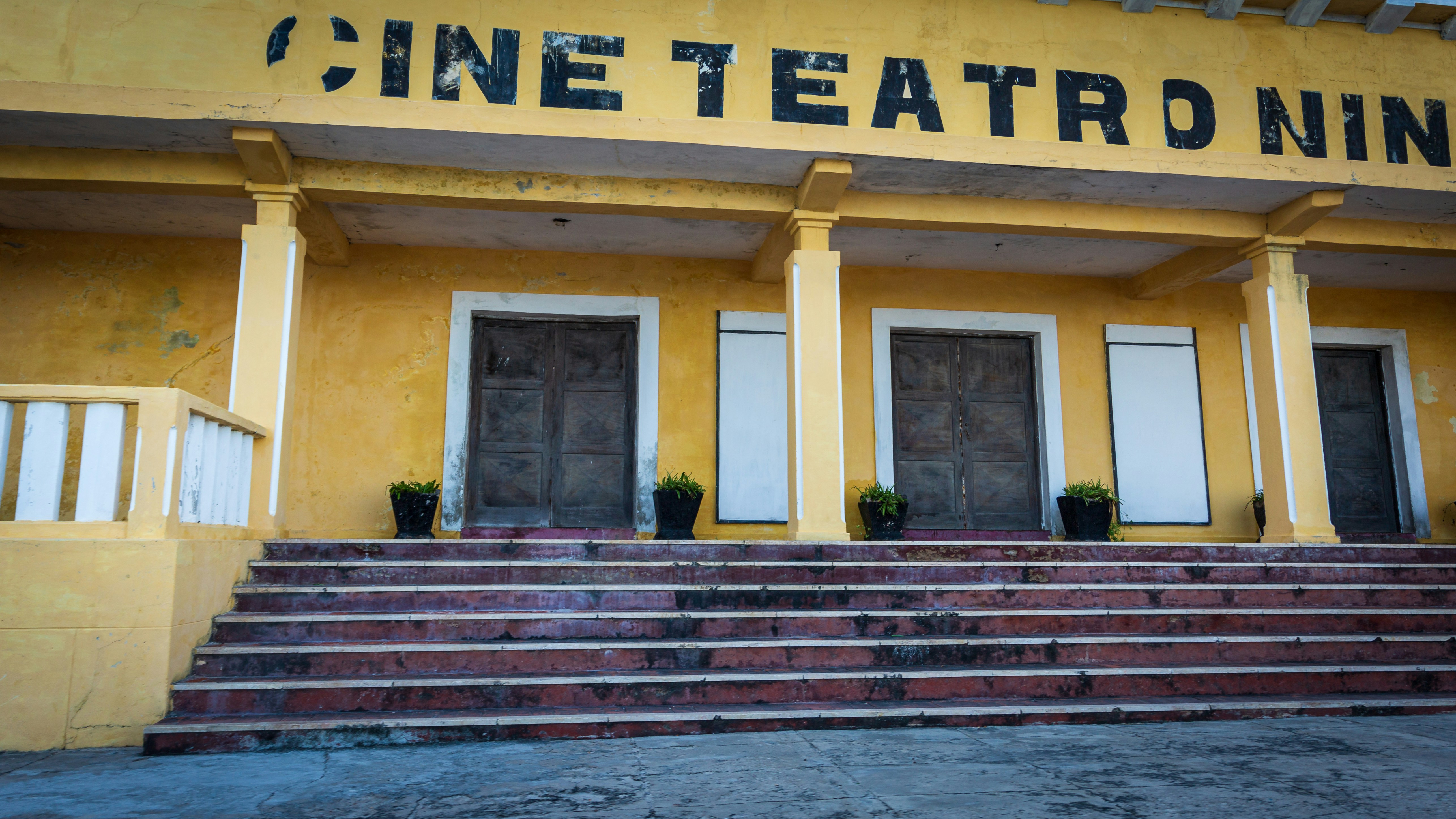 A yellow building with steps leading up to it
