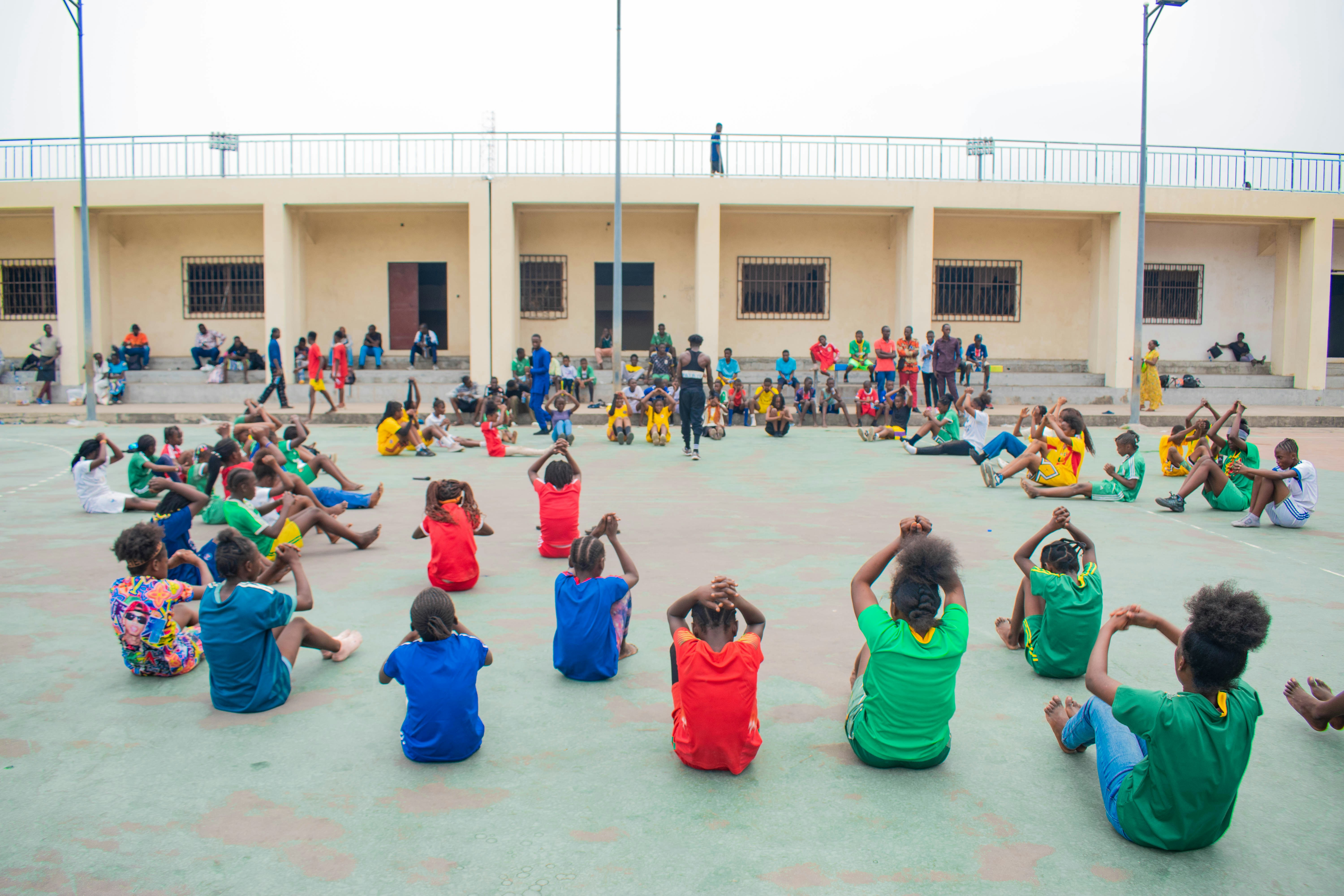 Children exercising in a circle outdoors