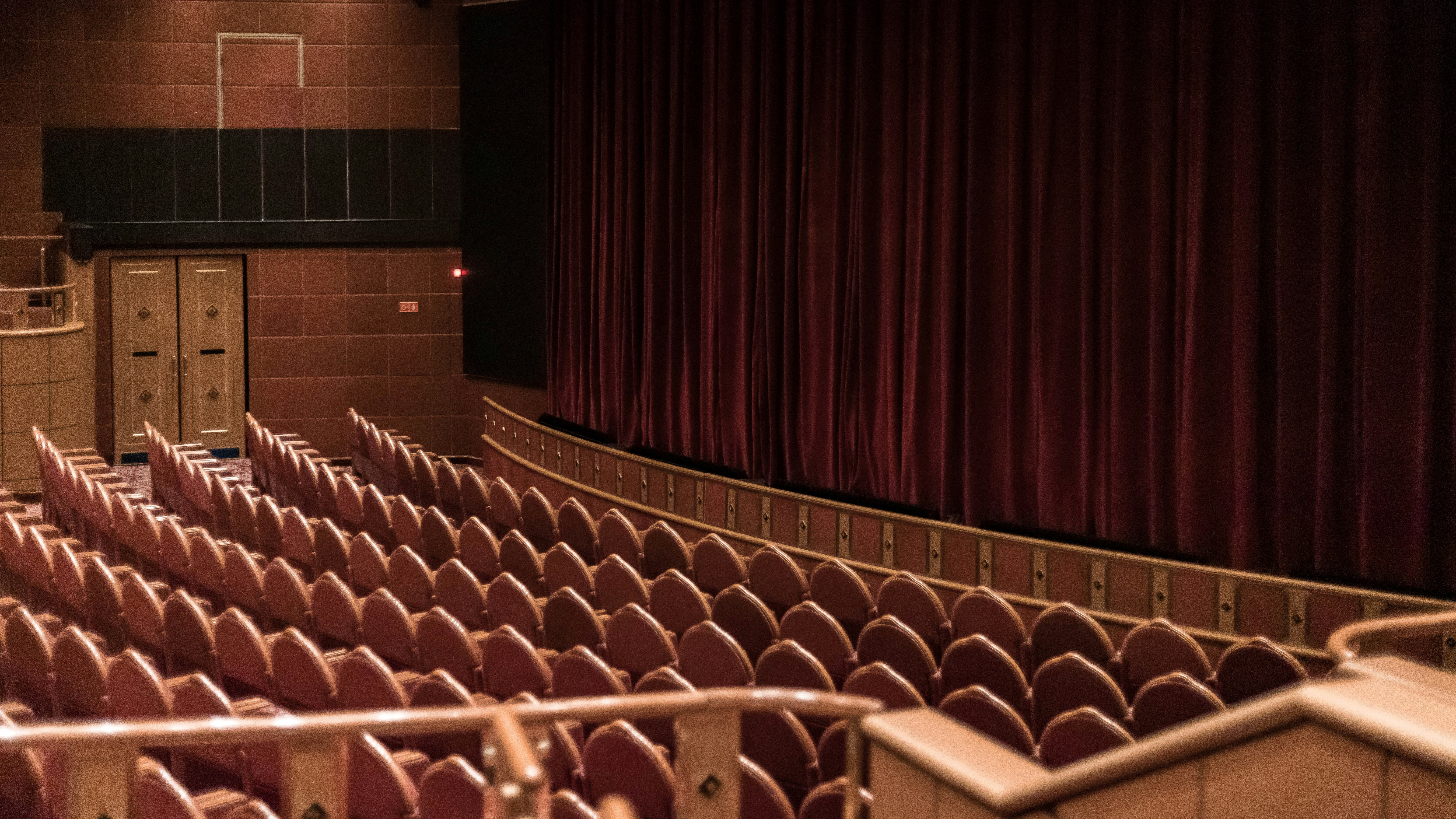 an empty auditorium with a red curtain