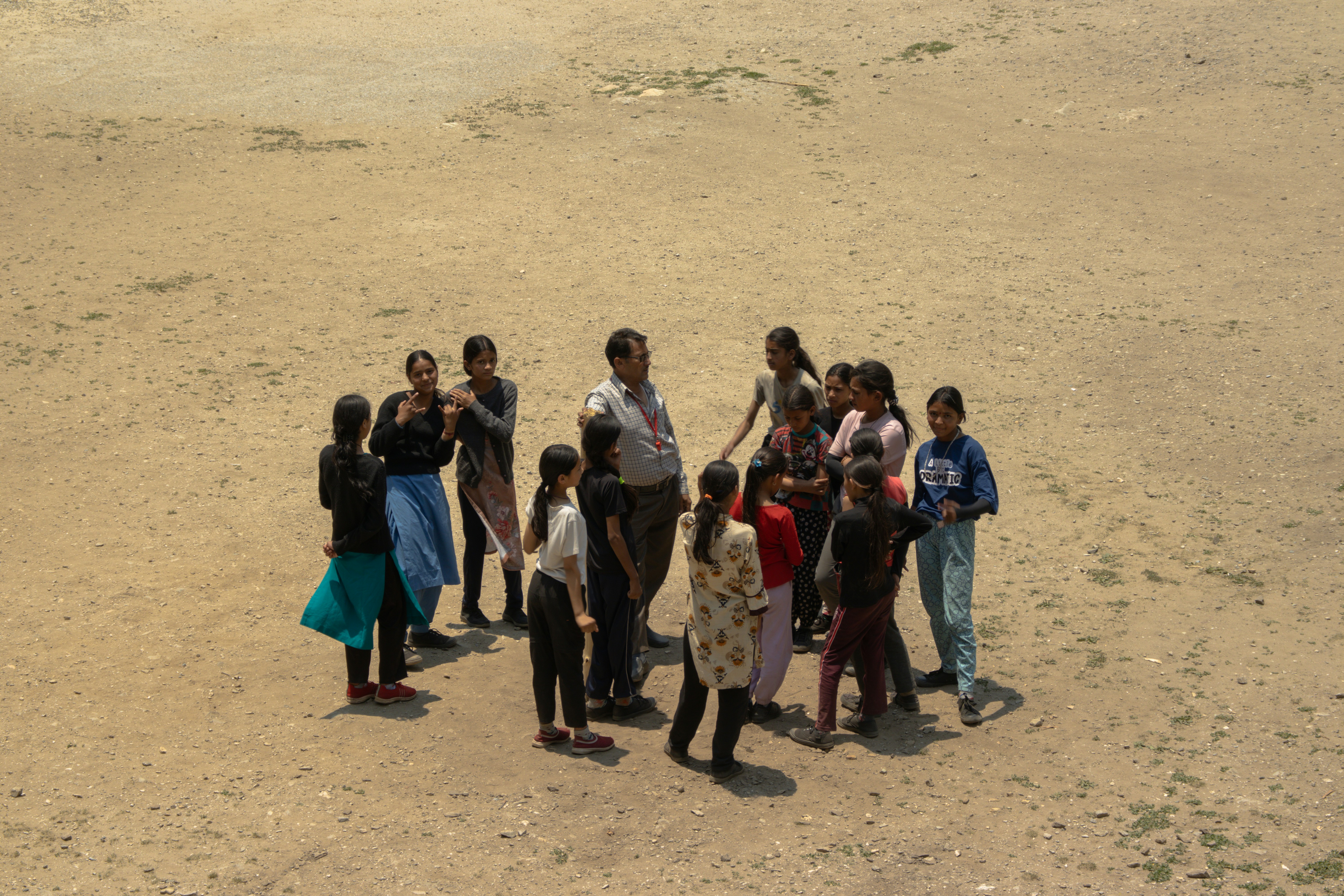 A group of people standing in the middle of a desert