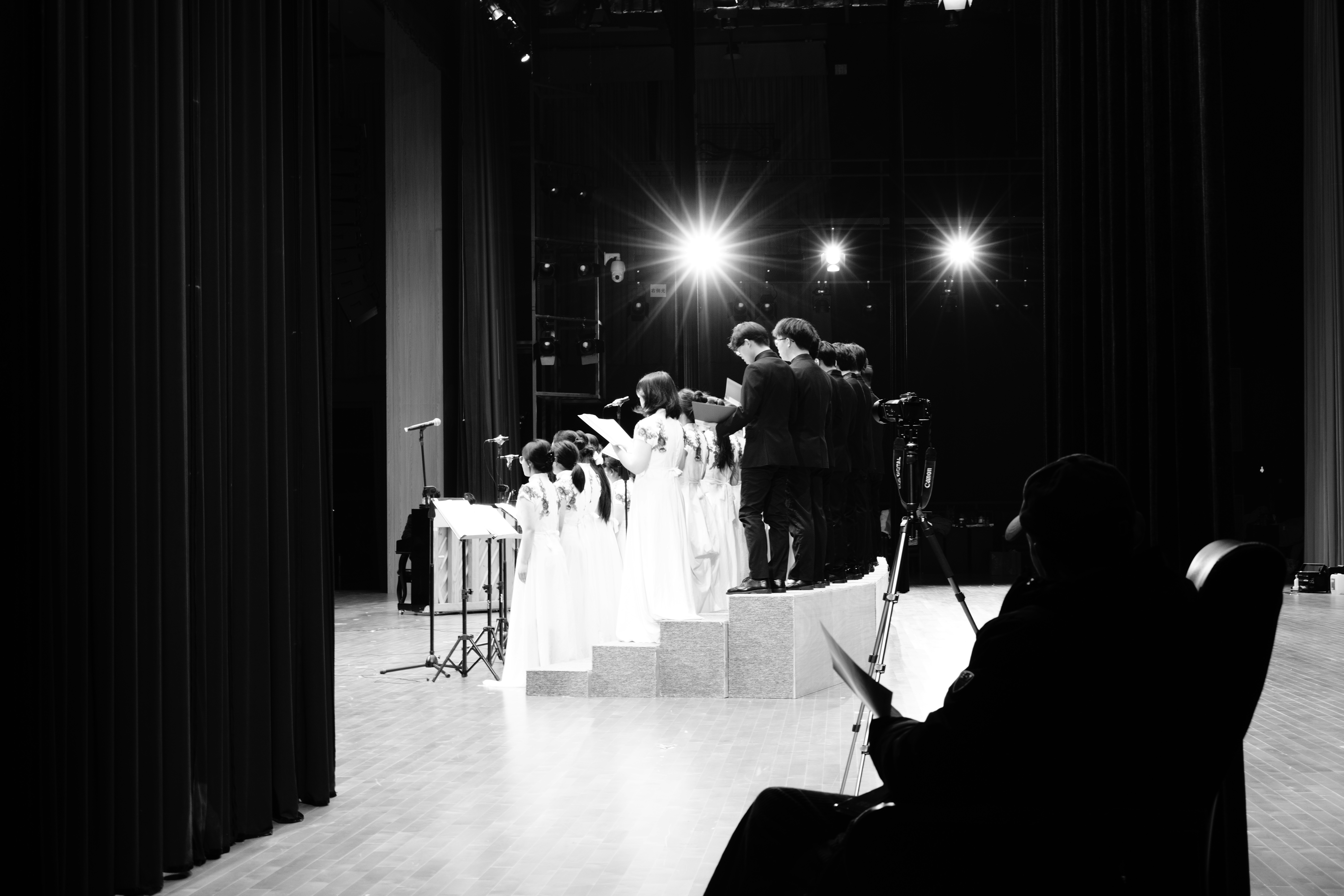 Choir performing on stage with spotlights