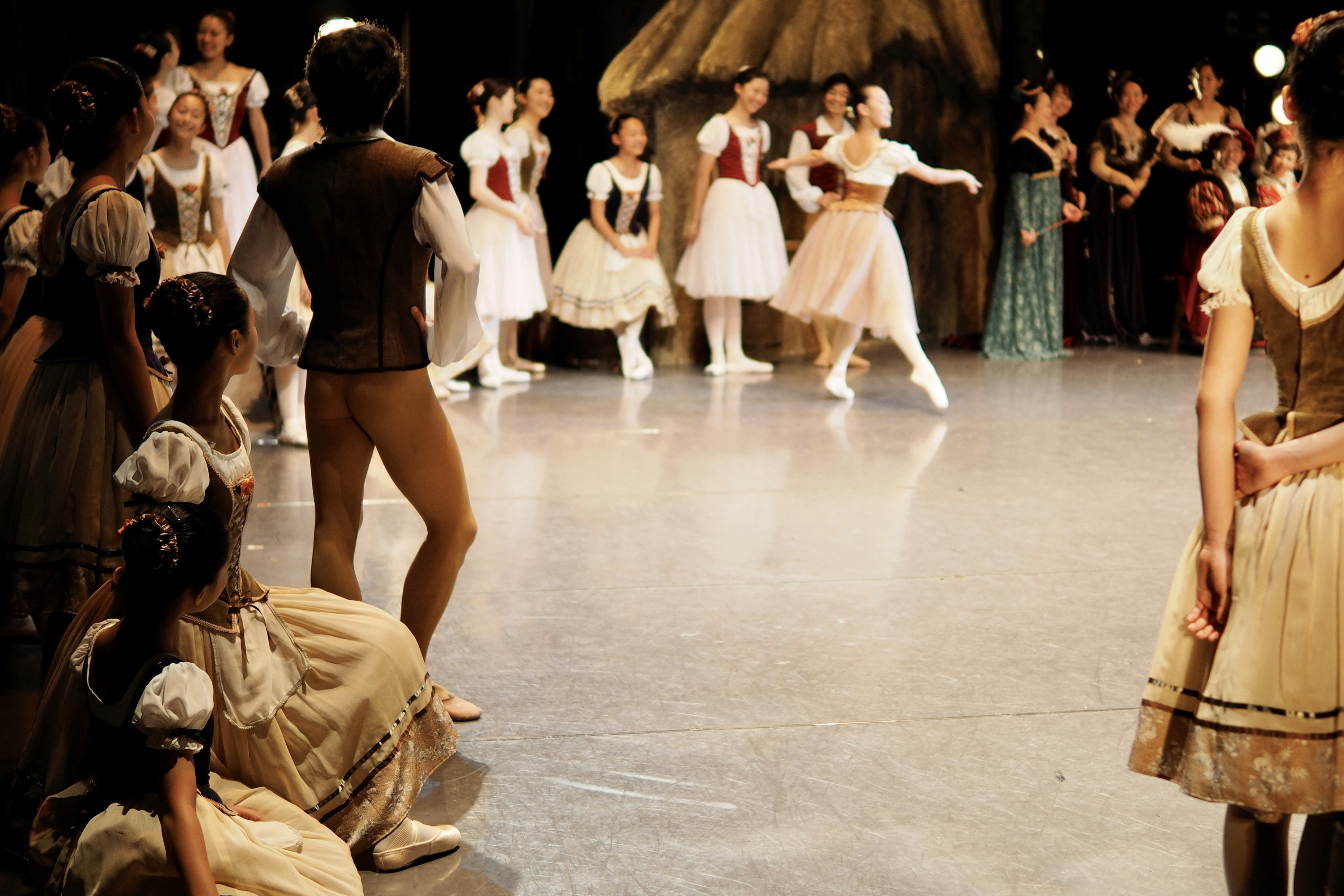 Ballet dancers in costume on stage during rehearsal
