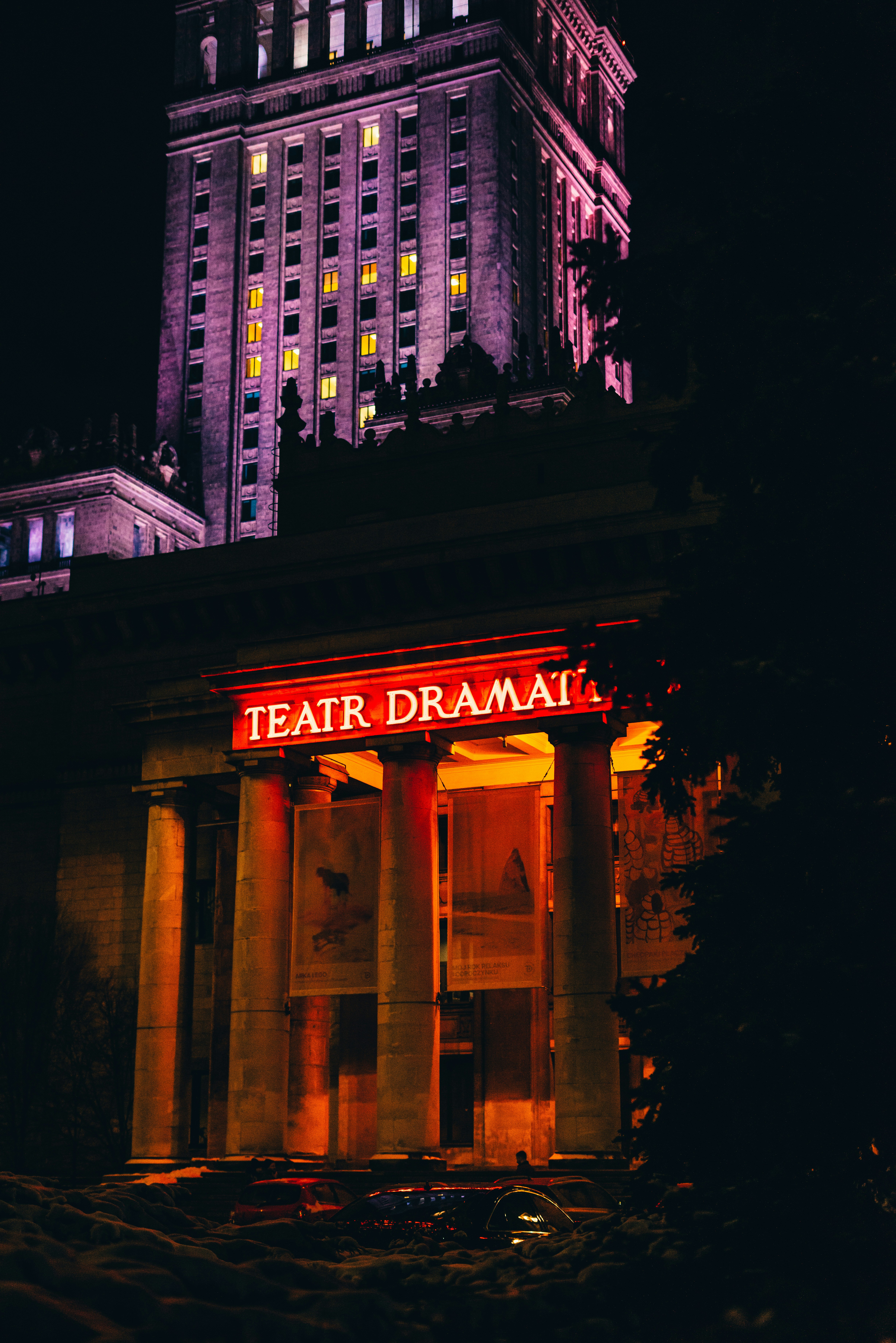 📜 The History of Free Play Scripts: From Public Domain to Digital Stages by School Play Scripts a tall building with a lit up sign in front of it