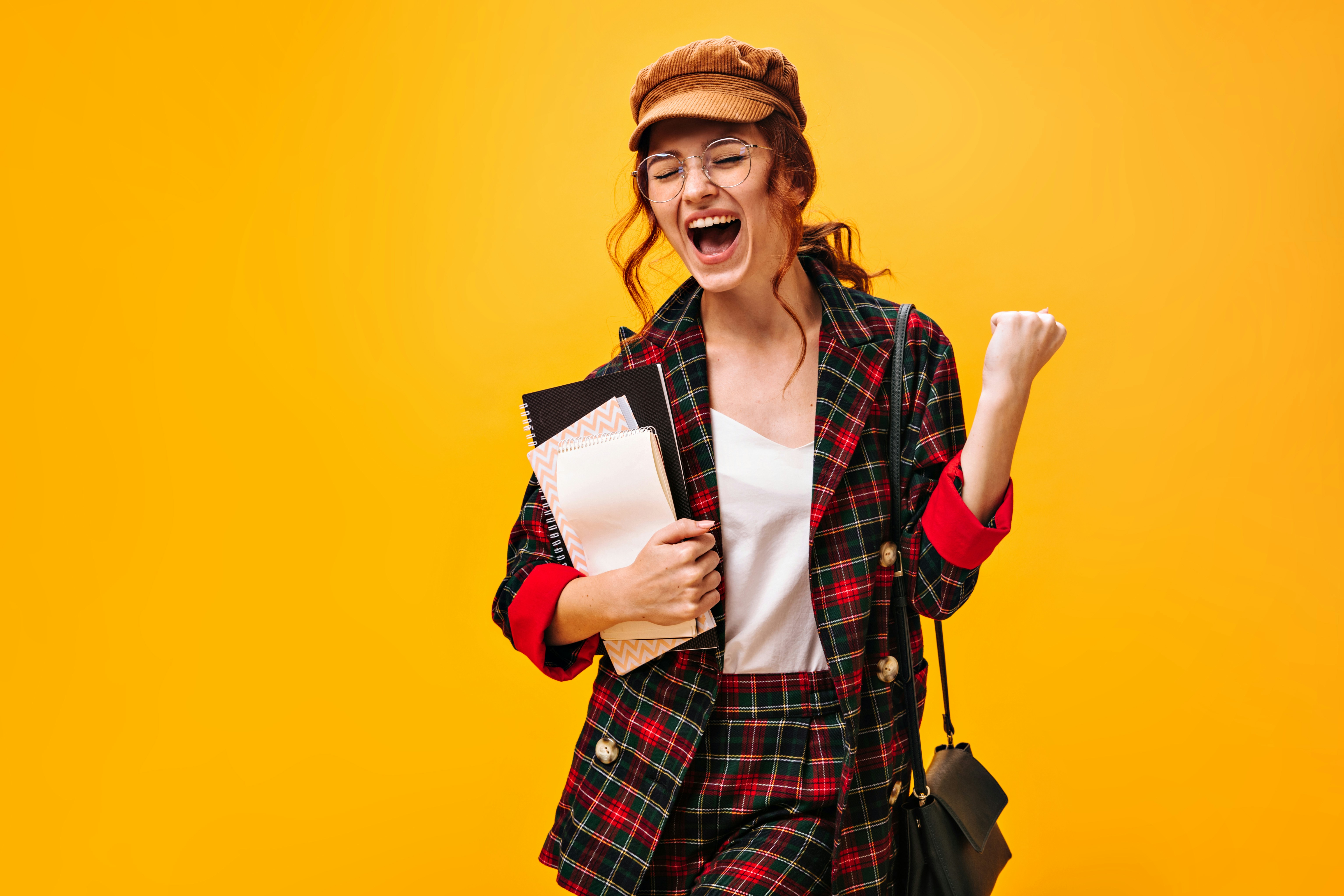 Where can I download play scripts? by School Play Scripts a woman in a plaid jacket holding a book and a bag