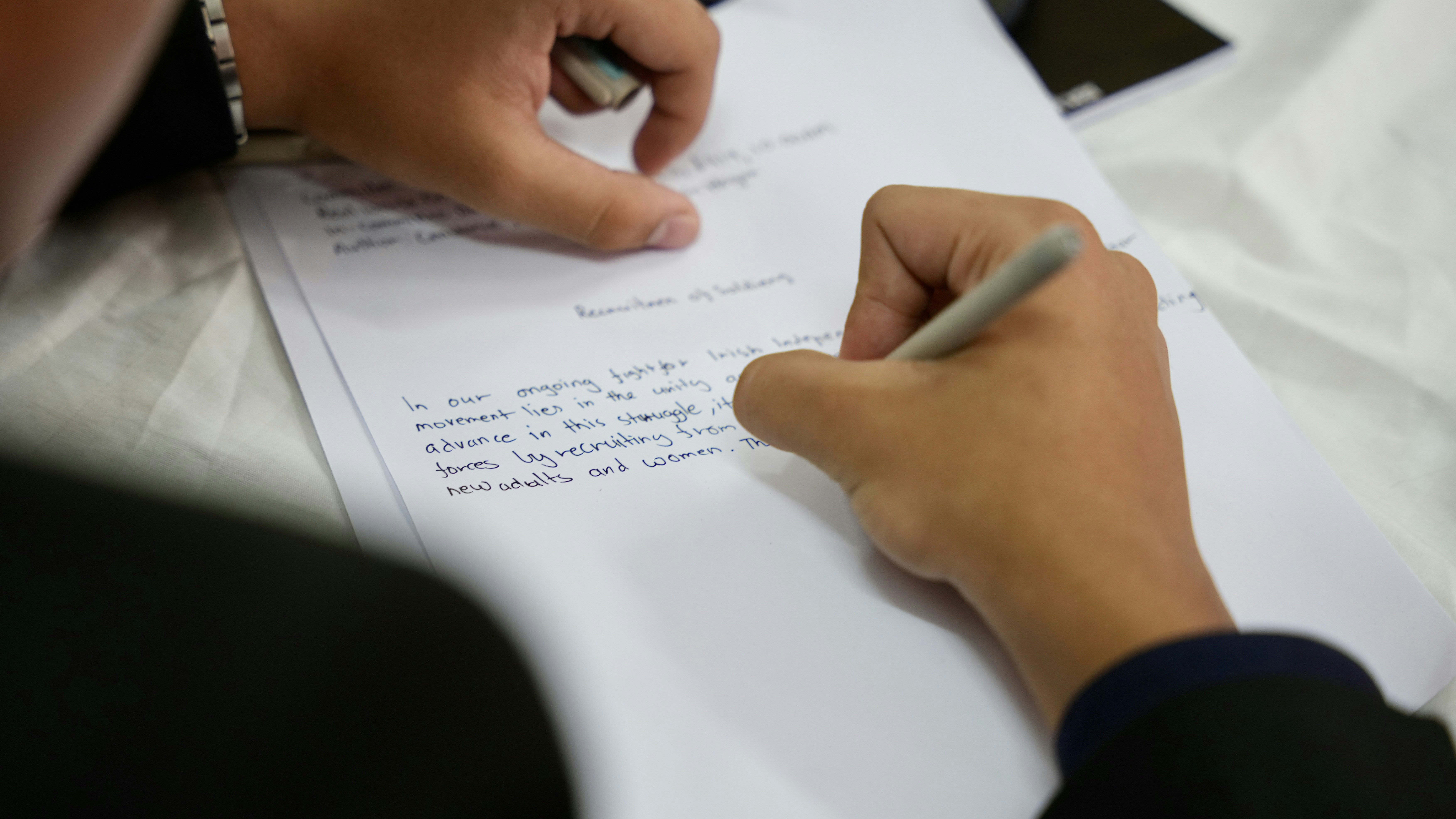 A Person Writing with a Pen Over the Shoulder Close Up by School Play Scripts A person writing on a piece of paper