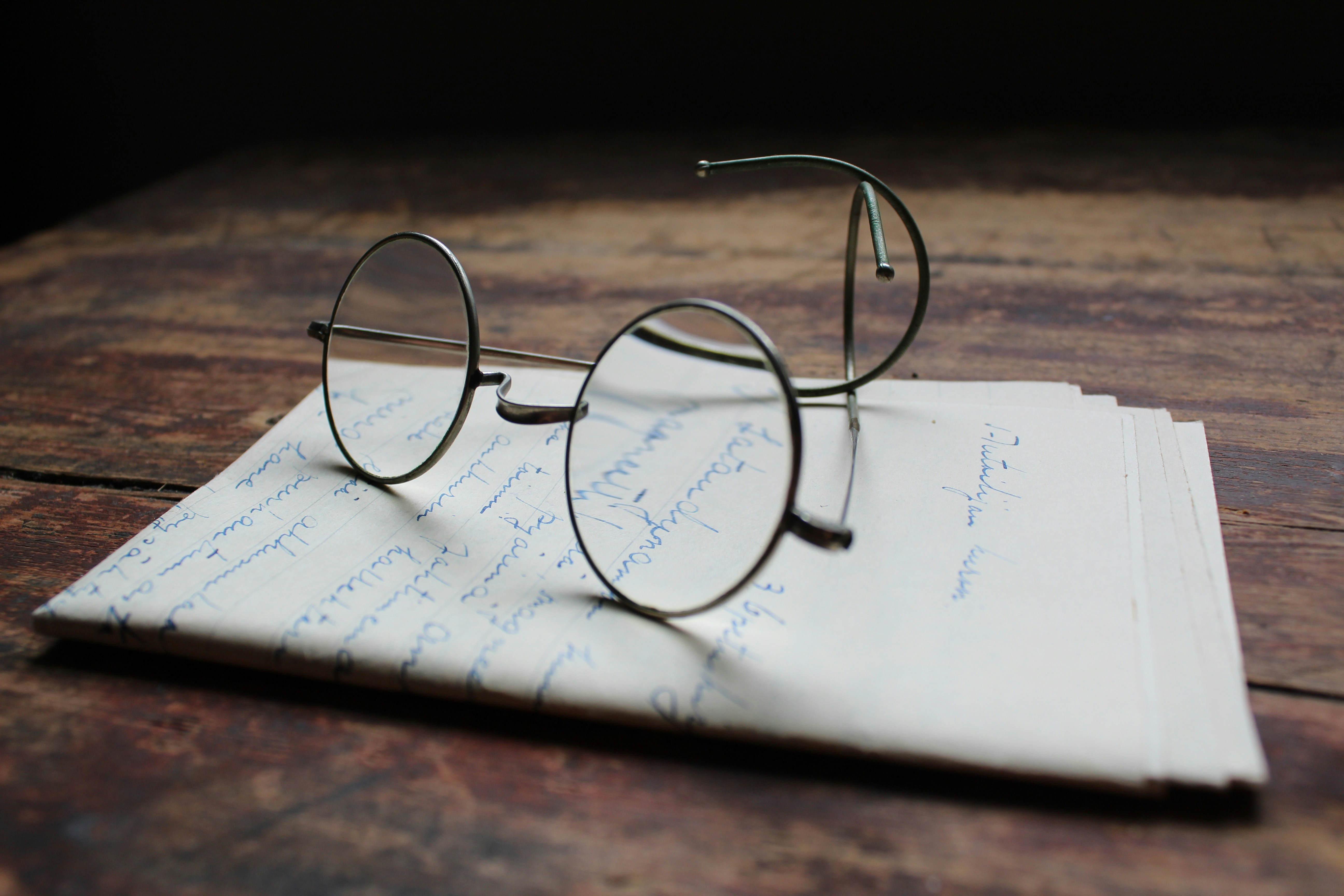 * Comedy school play scripts by School Play Scripts silver framed eyeglasses on white printer paper