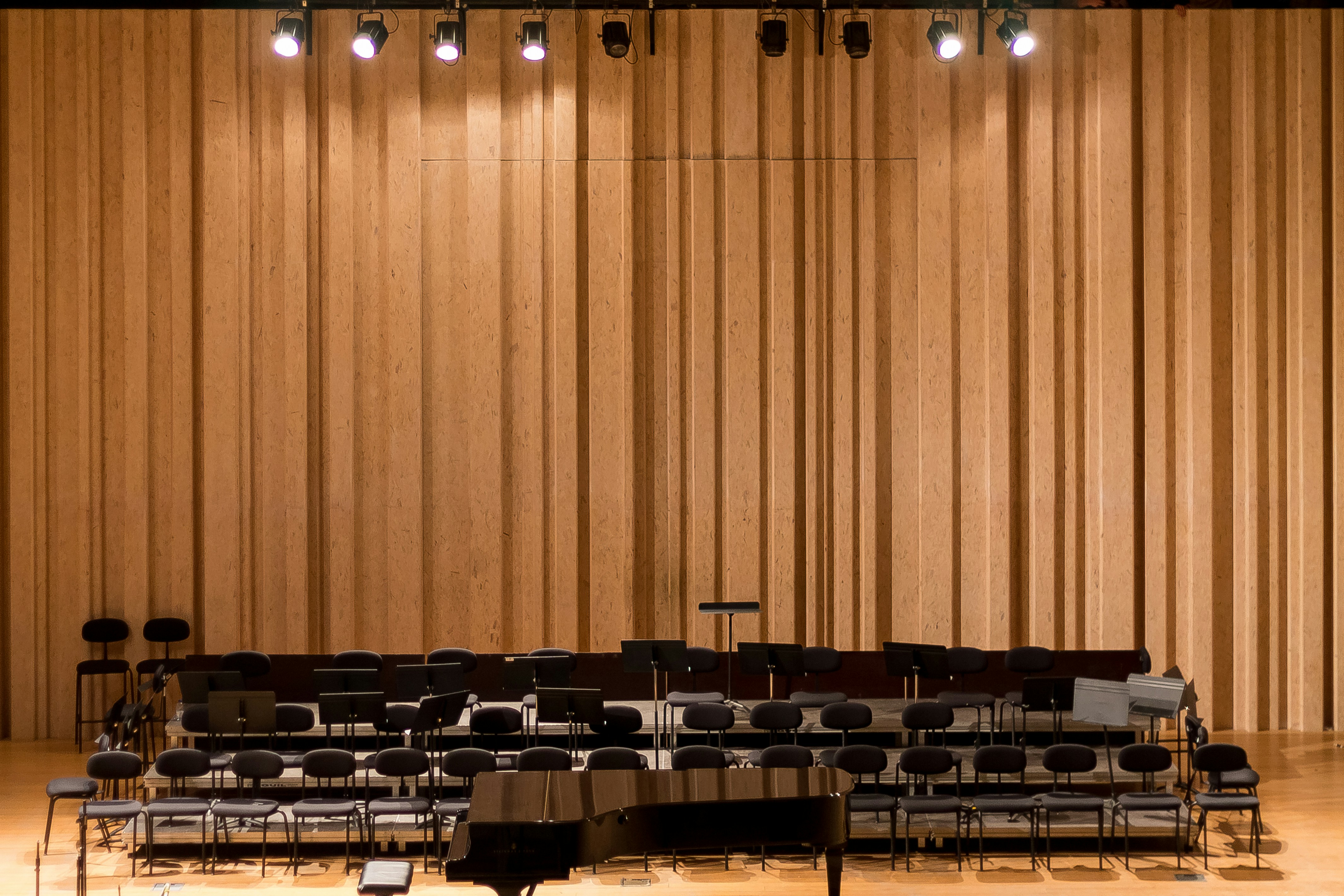The empty stage. by School Play Scripts a concert hall with rows of chairs and a piano