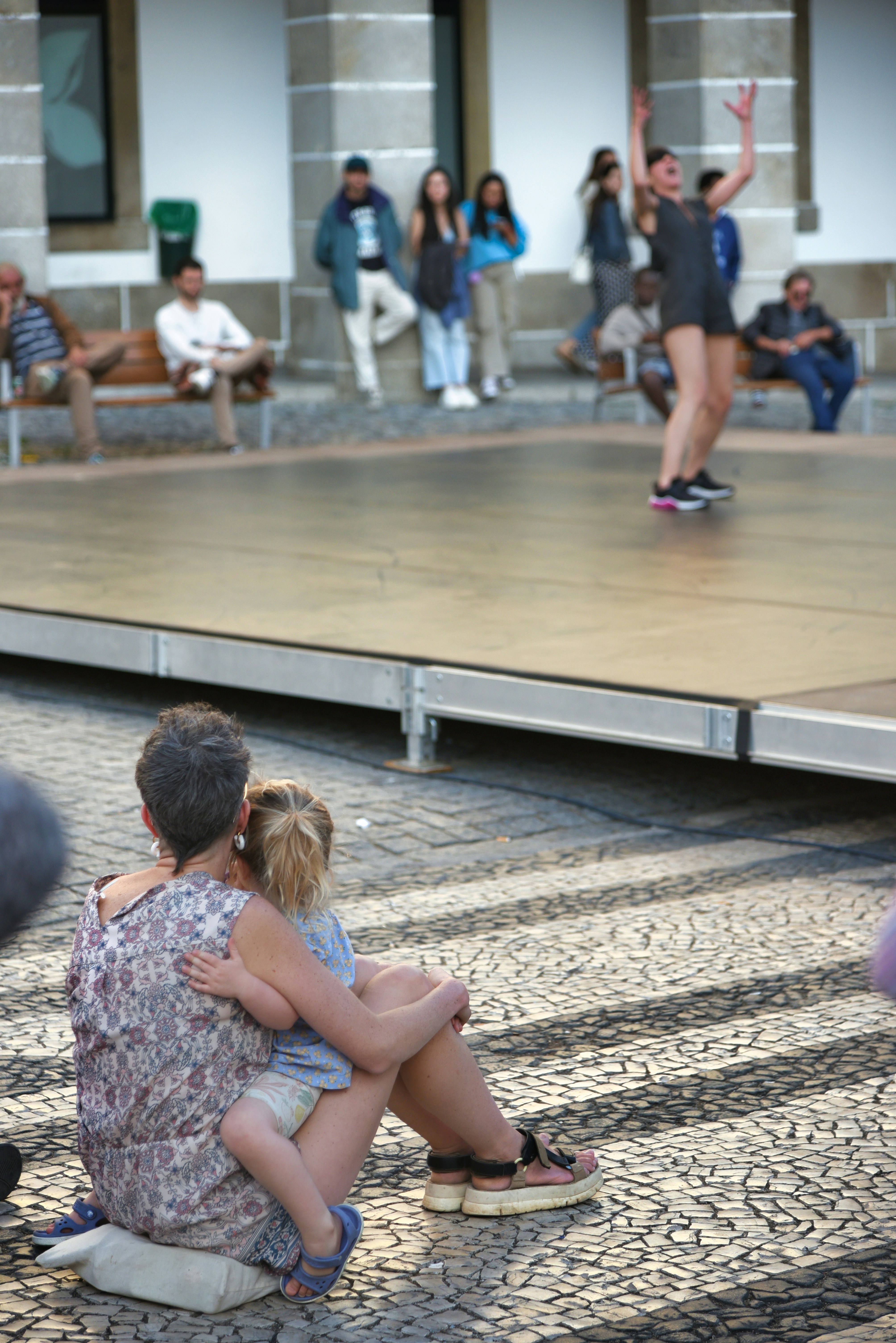 A couple of people that are sitting on the ground