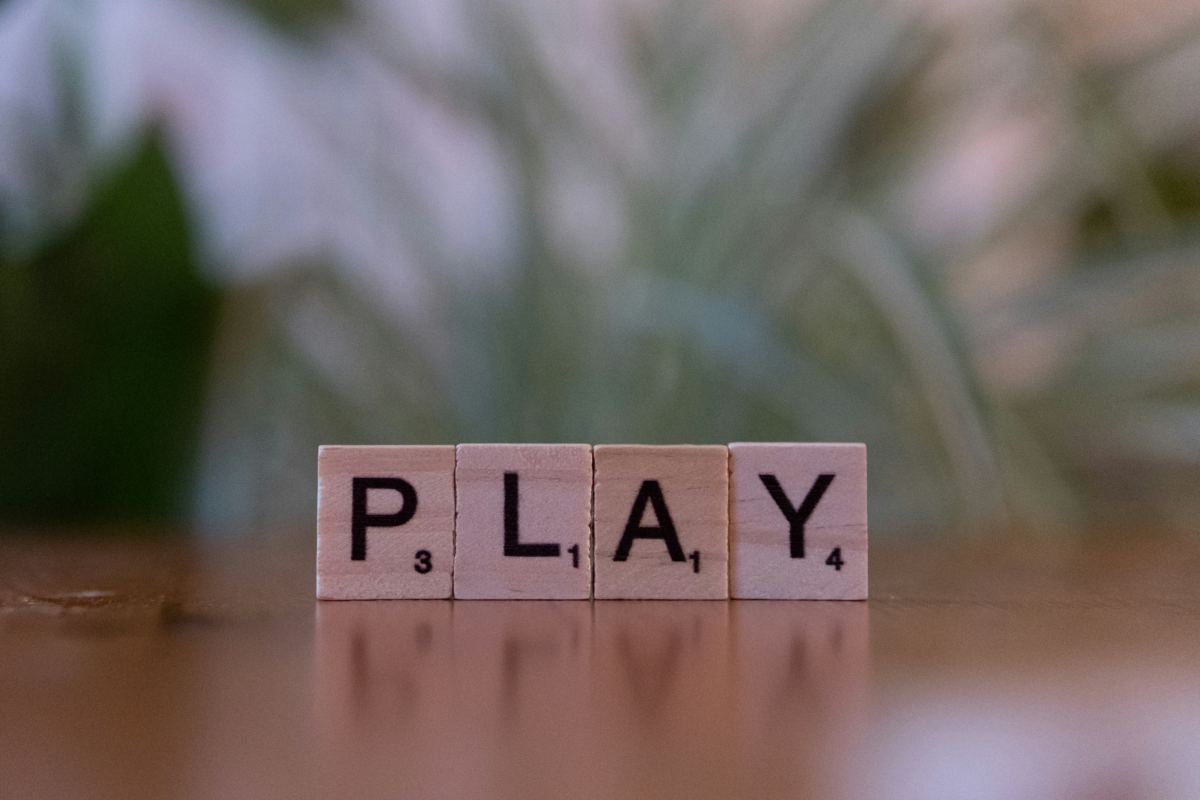 ❓ FAQ by School Play Scripts A wooden block spelling play on a table