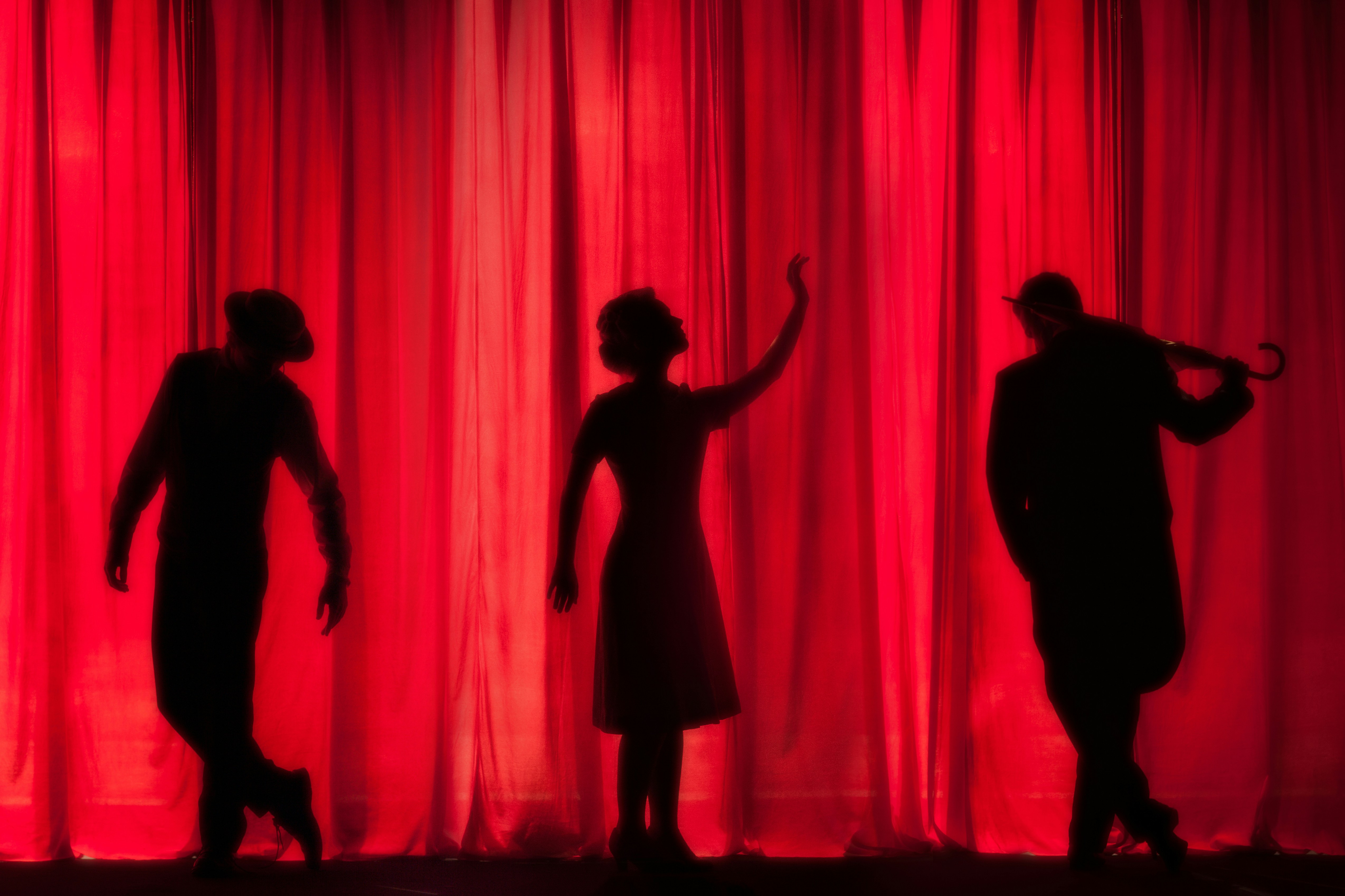My brother recently landed a feature role in an amateur theatre production of “Singing In The Rain”. Despite what the title infers - there is nothing amateur about it. Production value is high, and the acting takes you out of the auditorium and into your own magical sing-song world. Needless to say - a very proud brother right here. by School Play Scripts silhouette of three performers on stage