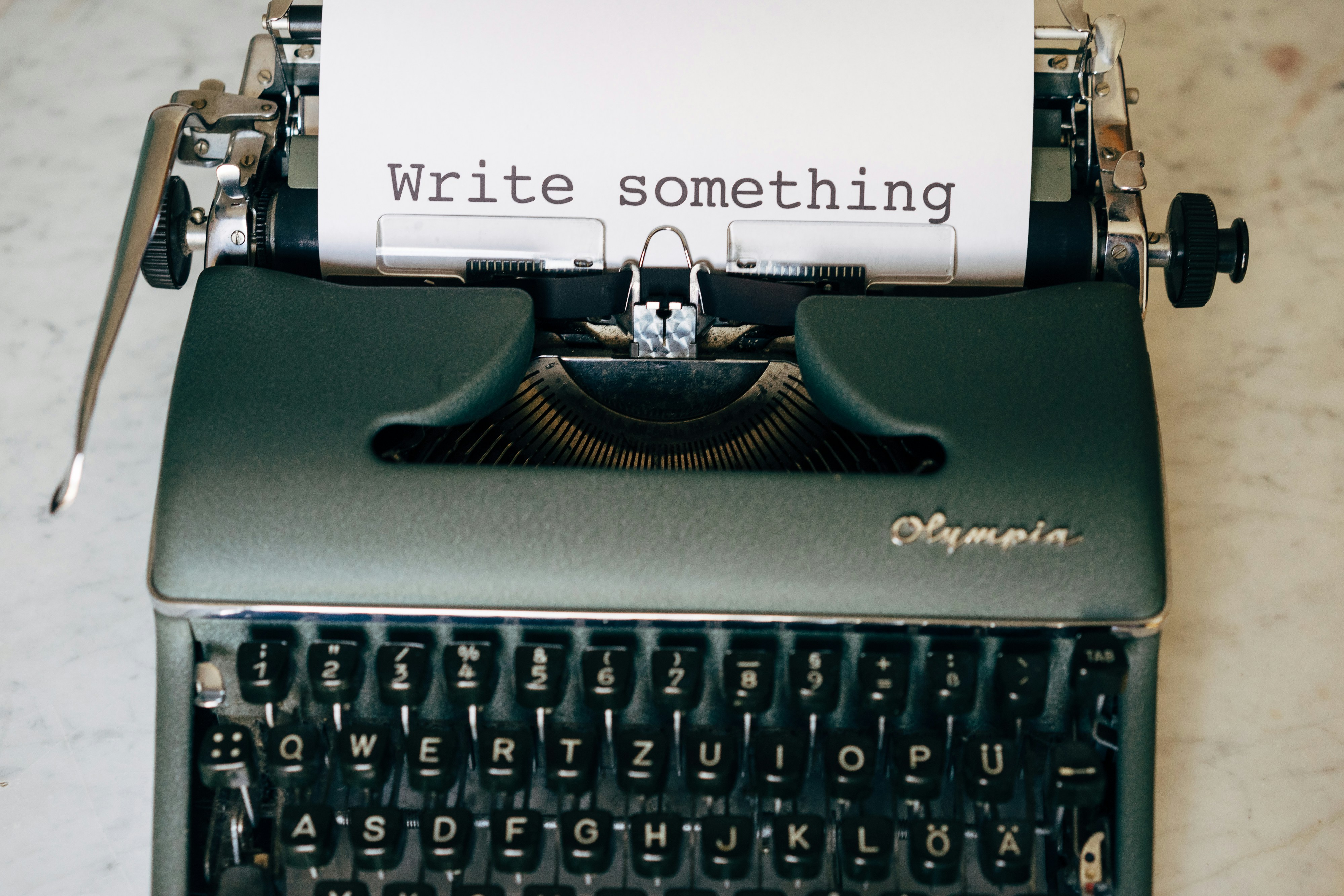 ❓ FAQ by School Play Scripts black and white typewriter on green table