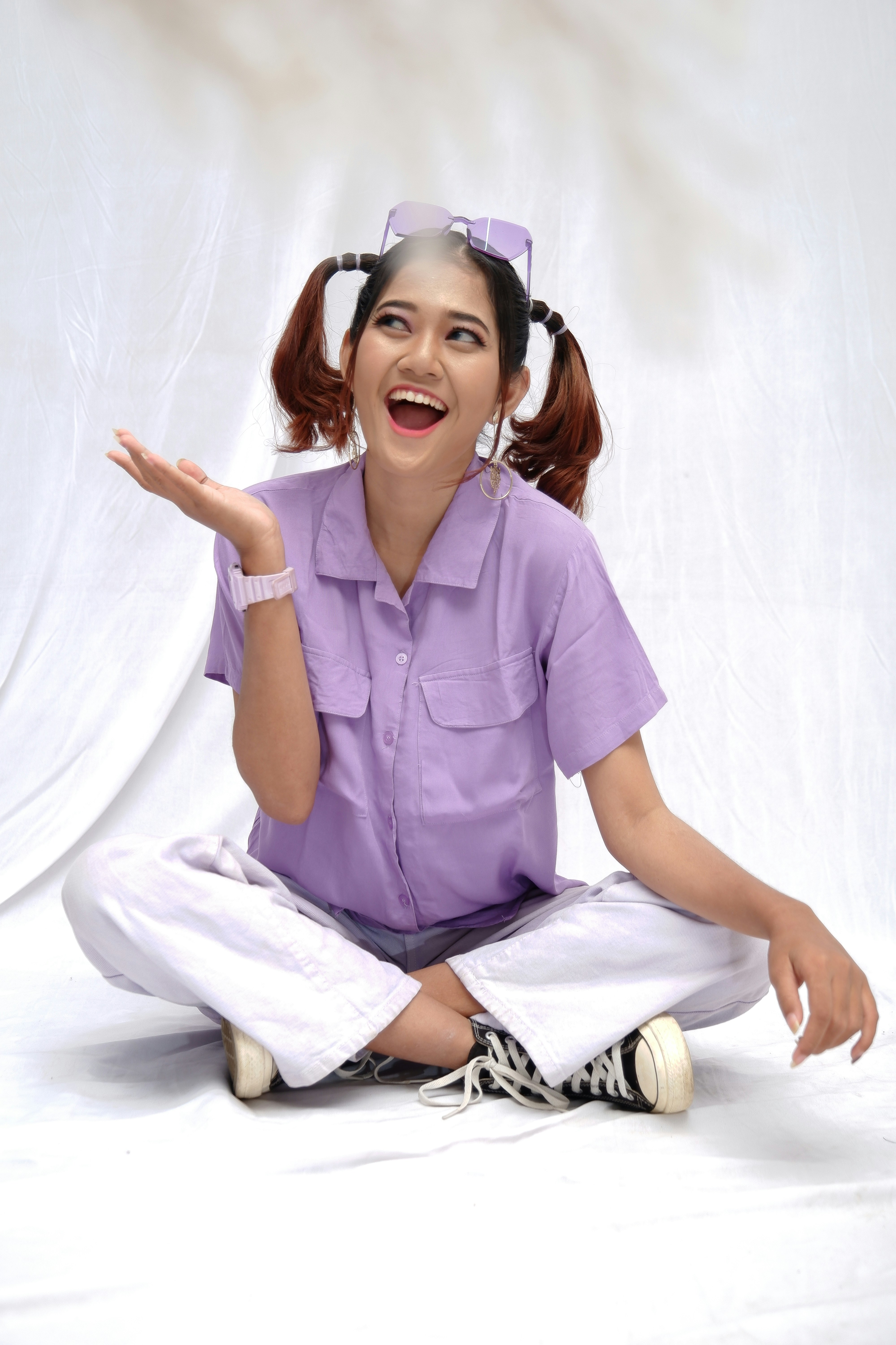 FAQ by School Play Scripts woman in purple polo shirt and white pants sitting on white floor