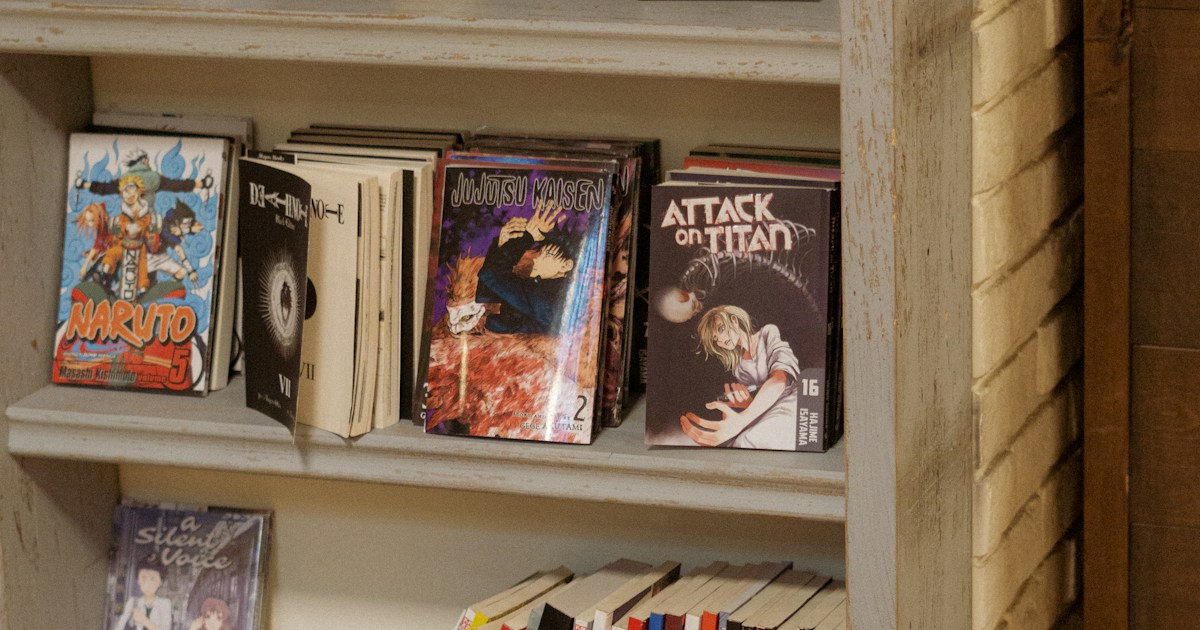 Attack on titan by School Play Scripts A bookshelf filled with lots of books on top of a hard wood floor