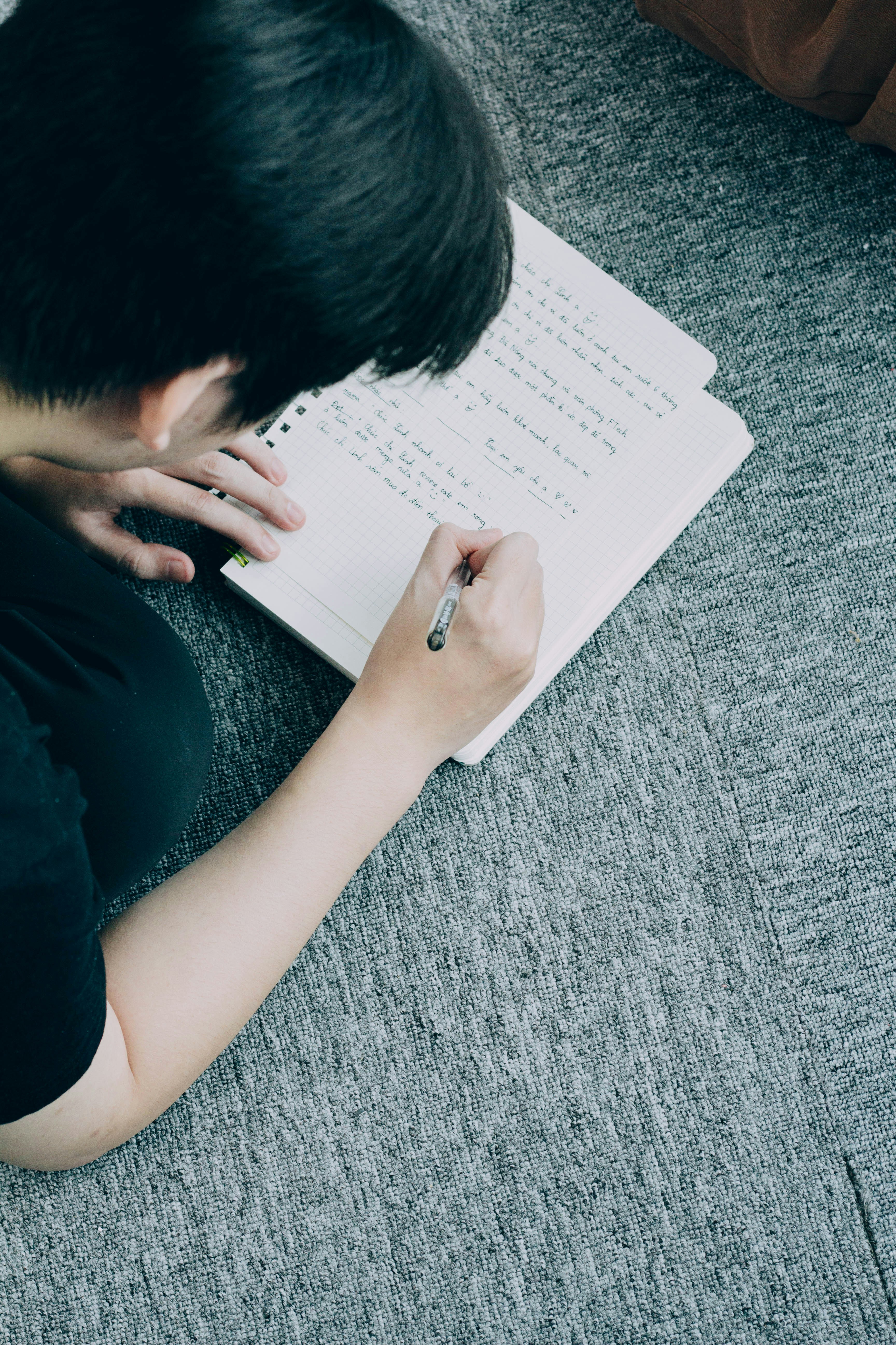 ❓ FAQ by School Play Scripts a person sitting on the floor writing on a notebook